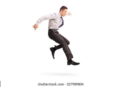 Full length profile shot of a young businessman jumping in the air isolated on white background