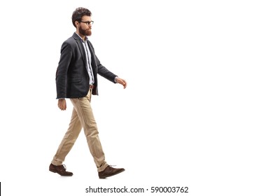 Full length profile shot of a young bearded man walking isolated on white background - Shutterstock ID 590003762