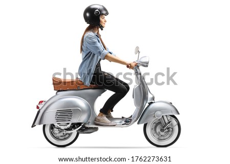 Full length profile shot of a young woman with a helmet riding a vintage scooter isolated on white background