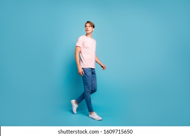 Full Length Profile Side Photo Of Serious Gorgeous Youth Guy Have Free Time Go Walk Through Part Look Copy Space Wear Modern Clothes Sneakers Isolated Over Blue Color Background