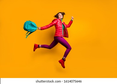 Full Length Profile Side Photo Of Cheerful Funky Youth Girl Jump Run College Work Day Hold Blue Backpack Wear Purple Shine Stylish Trendy Clothes Red Boots Isolated Yellow Color Background