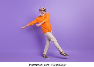 Full length profile side photo of mature man happy positive smile carefree have fun dance party isolated over violet color background
