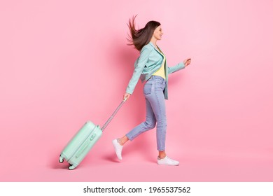 Full Length Profile Side Photo Of Charming Pretty Young Lady Walk Empty Space Travel Bag Isolated On Pink Color Background