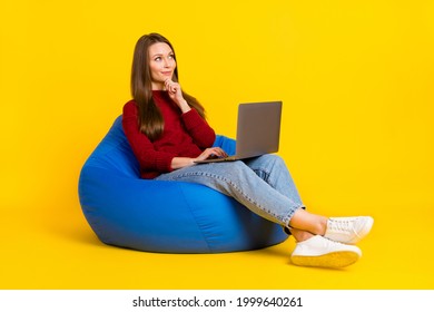 Full length profile side photo of young woman happy positive smile work latop think look empty space chair isolated over yellow color background