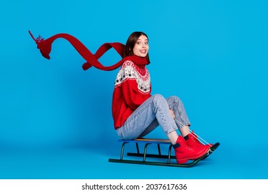 Full Length Profile Side Photo Of Young Girl Happy Positive Smile Winter Season Sled Air Scarf Isolated Over Blue Color Background