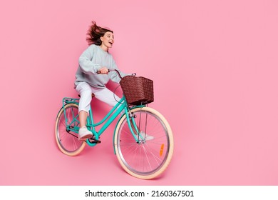 Full length profile side photo of young pretty woman good mood look empty space isolated over pink color background