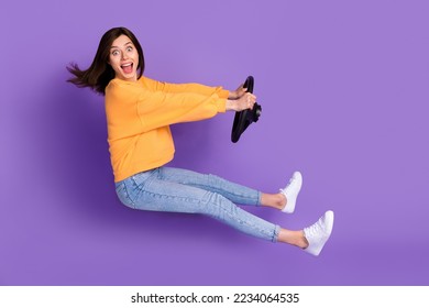 Full length profile side photo of overjoyed cool lady new car owner enjoy vehicle test drive lesson isolated on purple color background