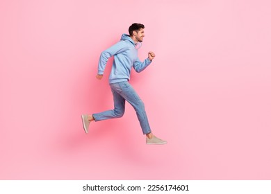Full length profile side photo of optimistic stylish man moving empty space hurry buy low prices clothes isolated on pink color background - Shutterstock ID 2256174601