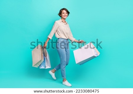 Full length profile side photo of charming lady hurry boutique nice stylish collection empty space isolated on cyan color background