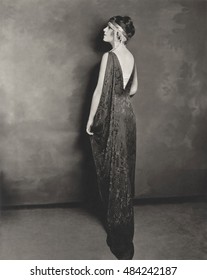 Full length profile of young woman in evening gown