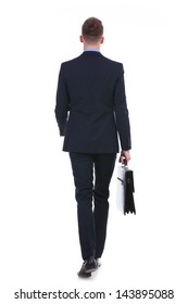 Full Length Rear View Picture Of A Young Business Man Walking Away From The Camera With A Suitcase In His Hand. On White Background