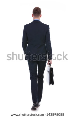 full length rear view picture of a young business man walking away from the camera with a suitcase in his hand. on white background