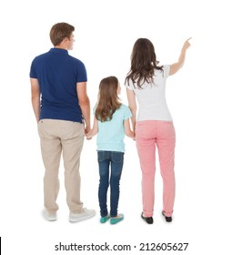 Full length rear view of woman showing something to family over white background