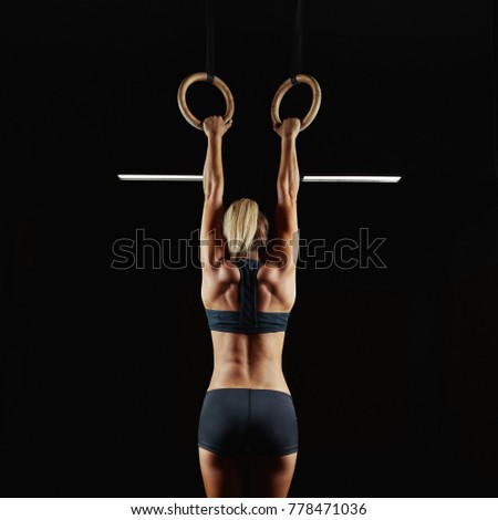 Similar – Image, Stock Photo Rear view portrait of one young middle age athletic woman at crossfit training, exercising with trx suspension fitness straps over dark background