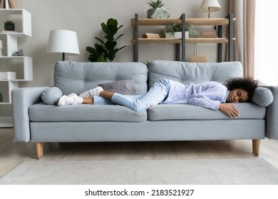 Full length relaxed African American woman sleeping on comfortable couch at home alone, beautiful young female resting with closed eyes, taking day nap, feeling tired and exhausted, lack of energy - Shutterstock ID 2183521927
