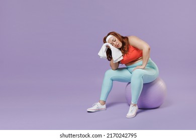 Full length sad sweating exhausted tired young chubby overweight plus size big fat woman in top warm up train sit on fit ball rest during break isolated on purple background gym Workout sport concept. - Powered by Shutterstock