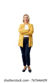 Full Length Shot Of An Attractive Mature Woman Smiling At The Camera While Standing Against At Isolated White Background.