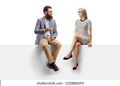 Full Length Shot Of A Bearded Man Talking To A Blond Woman Seated On A Panel Isolated On White Background