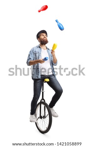 Full length shot of a bearded man on a unicycle juggling with clubs isolated on white background
