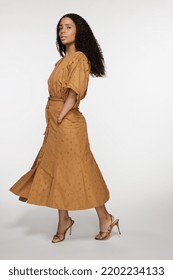 Full Length Shot Of Beautiful African American Woman In Her 30s With Gorgeous Hair Posing Confidently On White Background