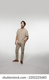 Full Length Shot Of Beautiful East Asian Man In His 40s Posing Confidently On White Background