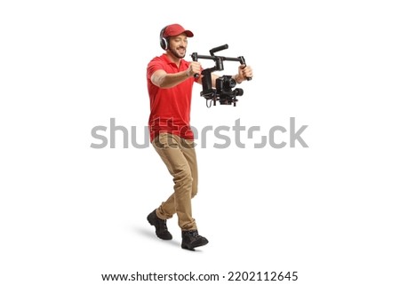 Full length shot of a camera operator walking and using a camera stabilizer isolated on white background