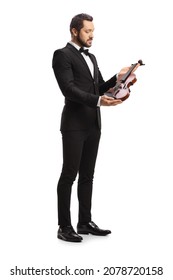 Full Length Shot Of An Elegant Male Violinist Looking At A Violin Isolated On White Background 