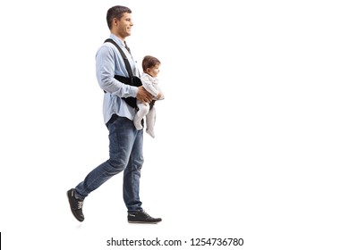 Full Length Shot Of A Father Walking With A Baby In Carrier  Isolated On White Background