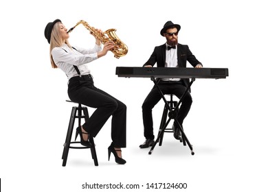 Full length shot of a female saxophonist and a male keyboard player isolated on white background