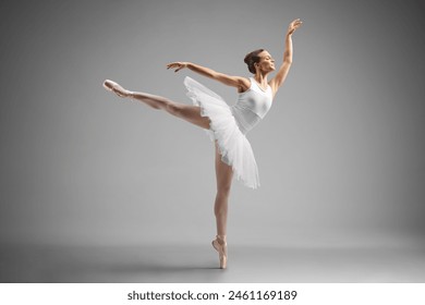 Full length shot of a graceful ballerina dancing isolated on gray background - Powered by Shutterstock