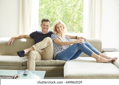 Full Length Shot A Happy Mature Couple Sitting On Couch At Home And Relaxing Togetherness. 