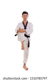 Full length shot of a male martial artist pull up his right knee for muscle stretching move, isolated over white background