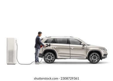 Full length shot of a man charging a SUV from an electric  vehicle station isolated on white background - Powered by Shutterstock