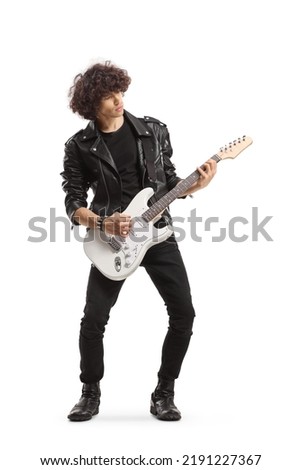 Full length shot of a man in a leather jacket playing an electric guitar isolated on white background