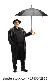 Full Length Shot Of A Mature Man In A Leather Trench Coat Holding An Open Umbrella Solated On White Background