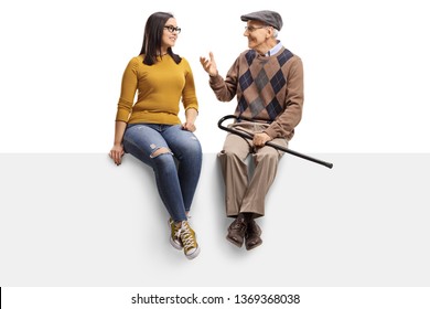 Full length shot of a senior man sitting on a panel and talking to a young girl isolated on white background