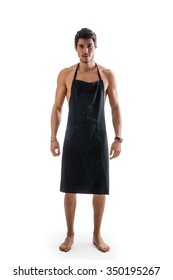 Full Length Shot Of Sexy Shirtless Young Chef Or Waiter Posing, Wearing Black Apron On Naked Body, Isolated On White Background