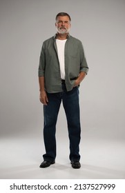 Full length shot of smiling mature man standing on white background. - Shutterstock ID 2137527999