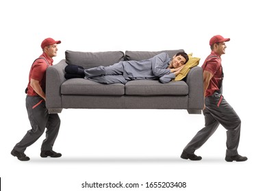 Full Length Shot Of Two Movers Carrying A Couch And A Man In Pajamas Sleeping On It Isolated On White Background 