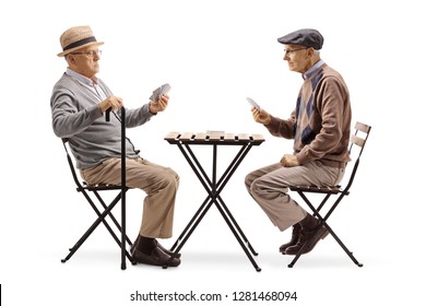 Full Length Shot Of Two Senior Men Playing Cards At A Table Isolated On White Background
