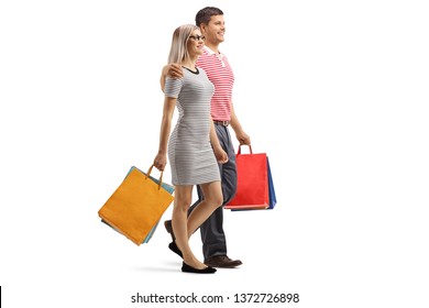 Full Length Shot Of A Young Couple Walking With Shopping Bags Isolated On White Background