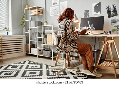 Full Length Shot Of Young Female Creator At Home Office Workplace With Graphic Prints, Copy Space