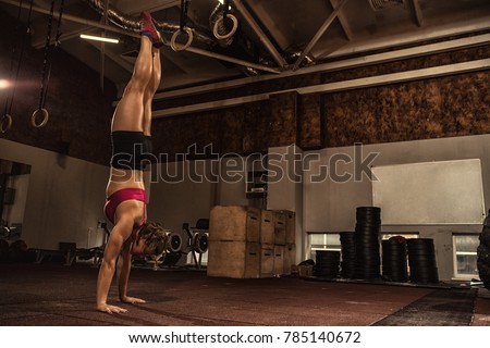 Full length shot of a young fitness woman doing handstand at the gym copyspace workout training balance athletics sports motivation crossfit motivation determination concentration healthy lifestyle
