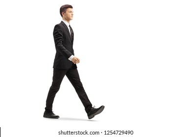 Full Length Shot Of A Young Handsome Man In A Black Suit Walking Isolated On White Background