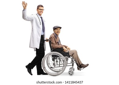 Full length shot of a young male doctor waving and pushing an elderly male patient in a wheelchair isolated on white background - Powered by Shutterstock