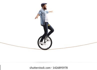 Full length shot of a young man riding a unicycle on a rope and balancing with hands isolated on white background - Powered by Shutterstock