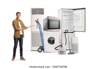 Full Length Shot Of A Young Man Showing Home Electrical Appliances Isolated On White Background