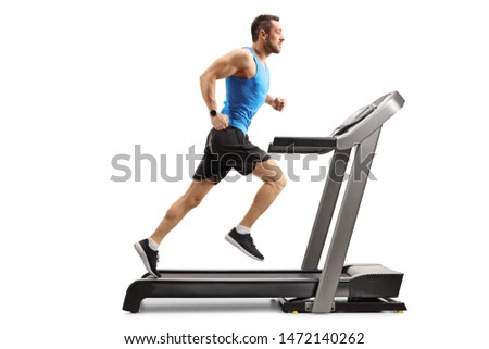 Full length shot of a young man in sportswear running on a professional treadmill isolated on white background