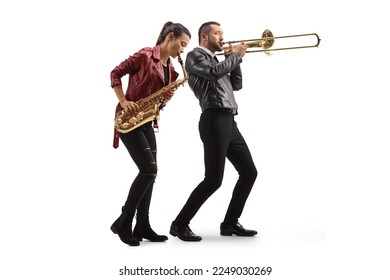 Full length shot of a young woman playing a sax and man playing a trombone isolated on white background