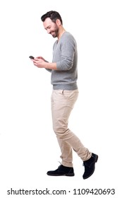 Full Length Side Portrait Of Man Walking With Mobile Phone